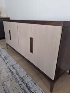 Contemporary credenza featuring light oak wood doors with dark walnut top and trim, modern vertical handles by Polymita Woodcraft